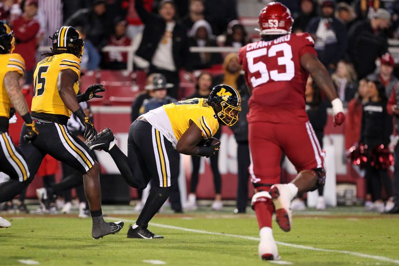 Nov 24, 2023; Fayetteville, Arkansas, USA; Missouri Tigers defensive lineman Jay Jernigan (0) picks up a fumble and returns it for a touchdown in the third quarter against the Arkansas Razorbacks at Donald W. Reynolds Razorback Stadium. Missouri won 48-14. Mandatory Credit: Nelson Chenault-USA TODAY Sports