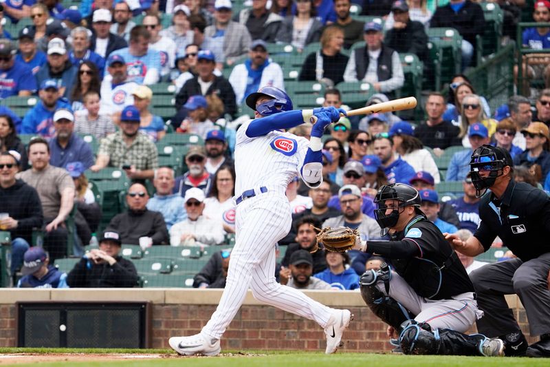 May 6, 2023; Chicago, Illinois, USA; Chicago Cubs second baseman Nico Hoerner (2) hits a single against the Miami Marlins during the first inning at Wrigley Field. Mandatory Credit: David Banks-USA TODAY Sports