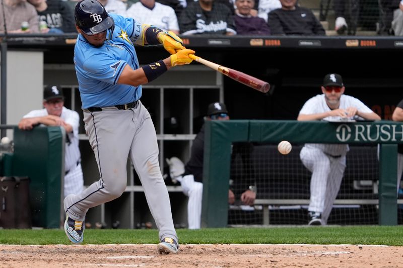 Apr 28, 2024; Chicago, Illinois, USA; Tampa Bay Rays third base Isaac Paredes (17) hits a single against the Chicago White Sox during the ninth inning  at Guaranteed Rate Field. Mandatory Credit: David Banks-USA TODAY Sports