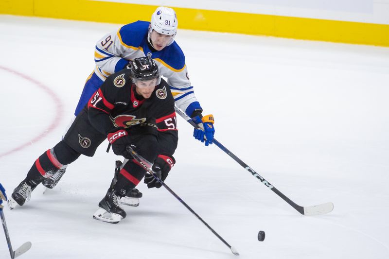 Sep 26, 2024; Ottawa, Ontario, CAN; Ottawa Senators left wing Cole Reinhardt (51) battles with Buffalo Sabres defenseman Nikita Novikov (91) in the third period at the Canadian Tire Centre. Mandatory Credit: Marc DesRosiers-Imagn Images