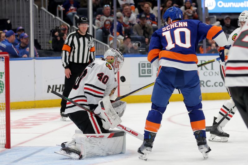 Mar 24, 2026; Elmont, New York, USA; Chicago Blackhawks goaltender Arvid Soderblom (40) makes a save against New York Islanders center Brayden Schenn (10) during the first period at UBS Arena. Mandatory Credit: Brad Penner-Imagn Images