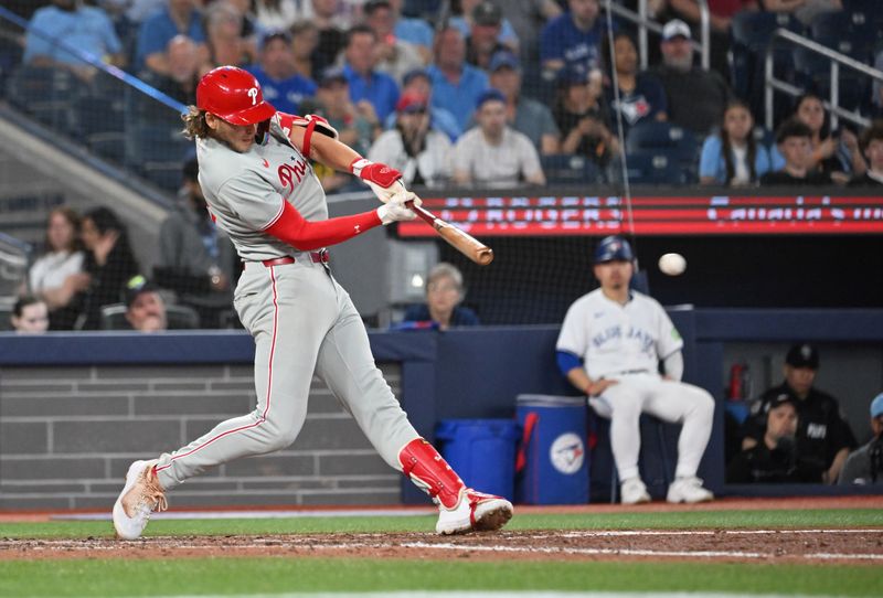 Jun 4, 2025; Toronto, Ontario, CAN;  Philadelphia Phillies third baseman Alec Bohm (28) hits a single against the Toronto Blue Jays in the ninth inning at Rogers Centre. Mandatory Credit: Dan Hamilton-Imagn Images