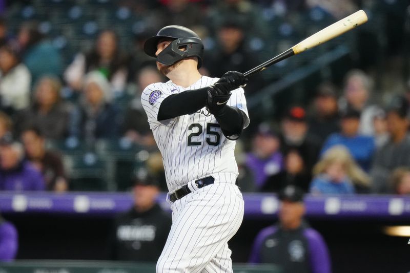 May 12, 2023; Denver, Colorado, USA; Colorado Rockies first baseman C.J. Cron (25) hits a RBI sacrifice fly in the sixth inning against the Philadelphia Phillies at Coors Field. Mandatory Credit: Ron Chenoy-USA TODAY Sports