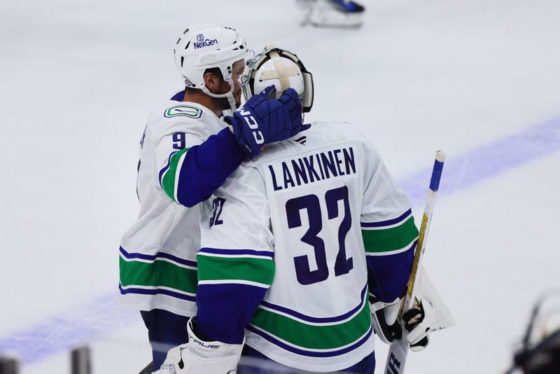 Oct 17, 2024; Sunrise, Florida, USA; Vancouver Canucks center J.T. Miller (9) and goaltender Kevin Lankinen (32) celebrate after the game against the Florida Panthers at Amerant Bank Arena. Mandatory Credit: Sam Navarro-Imagn Images