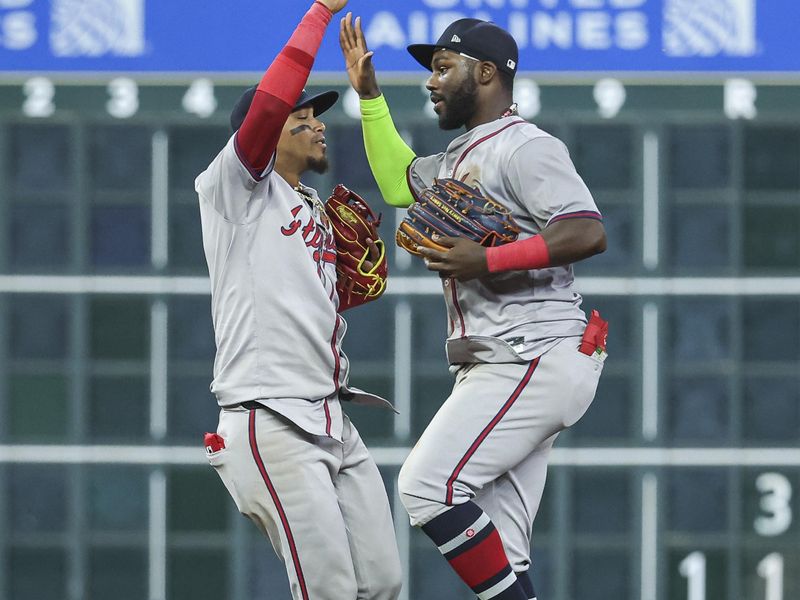 Apr 16, 2024; Houston, Texas, USA; Atlanta Braves shortstop Orlando Arcia (11) and center fielder Michael Harris II (23) celebrate after the game against the Houston Astros at Minute Maid Park. Mandatory Credit: Troy Taormina-USA TODAY Sports