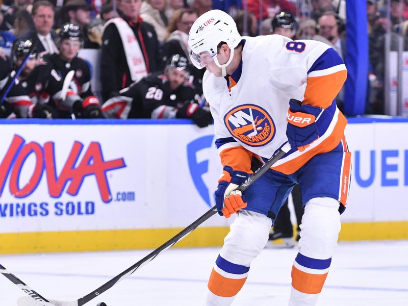 Oct 21, 2023; Buffalo, New York, USA; New York Islanders defenseman Noah Dobson (8) tries to control the puck in the third period against the Buffalo Sabres at KeyBank Center. Mandatory Credit: Mark Konezny-USA TODAY Sports