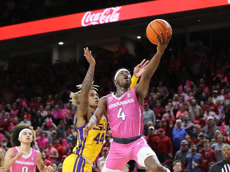 Jan 24, 2023; Fayetteville, Arkansas, USA; Arkansas Razorbacks guard Davonte Davis (4) shoots as LSU Tigers guard Adam Miller (44) defends during the first half at Bud Walton Arena. Mandatory Credit: Nelson Chenault-USA TODAY Sports