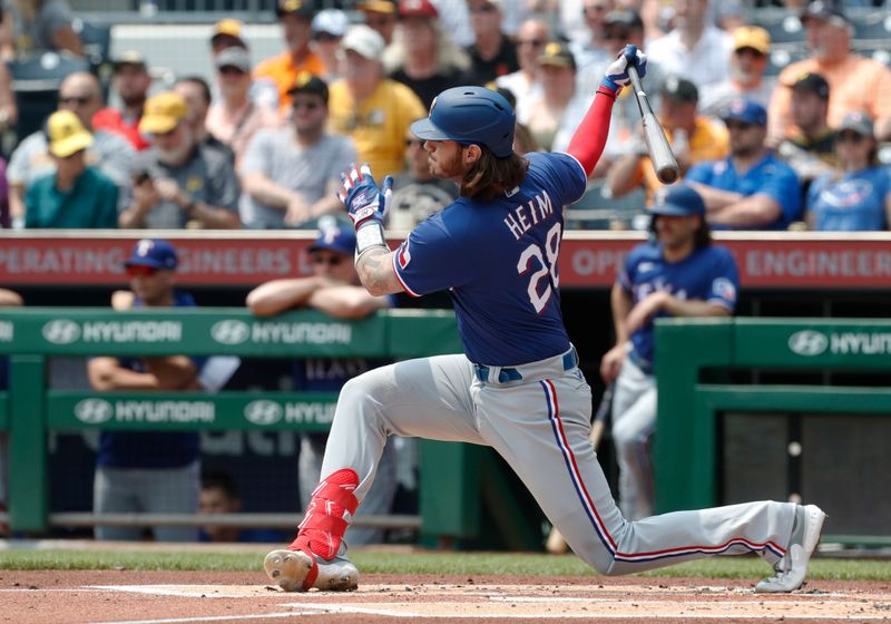 May 24, 2023; Pittsburgh, Pennsylvania, USA; Texas Rangers catcher Jonah Heim (28) drives in a run on a fielders choice against the Pittsburgh Pirates during the first inning at PNC Park. Mandatory Credit: Charles LeClaire-USA TODAY Sports