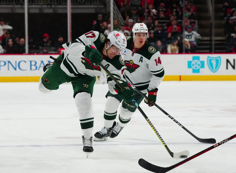 Jan 21, 2024; Raleigh, North Carolina, USA;  Minnesota Wild left wing Marcus Foligno (17) takes a shot against the Carolina Hurricanes during the second period at PNC Arena. Mandatory Credit: James Guillory-USA TODAY Sports