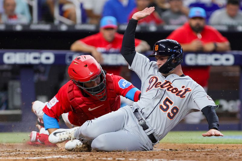 Jul 29, 2023; Miami, Florida, USA; Detroit Tigers second baseman Zack Short (59) is tagged out at home plate by Miami Marlins catcher Jacob Stallings (58) during the seventh inning at loanDepot Park. Mandatory Credit: Sam Navarro-USA TODAY Sports