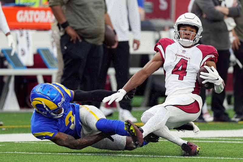 Arizona Cardinals wide receiver Rondale Moore (4) is tackled by Los Angeles Rams cornerback Troy Hill during the first half of an NFL football game Sunday, Nov. 13, 2022, in Inglewood, Calif. (AP Photo/Mark J. Terrill)