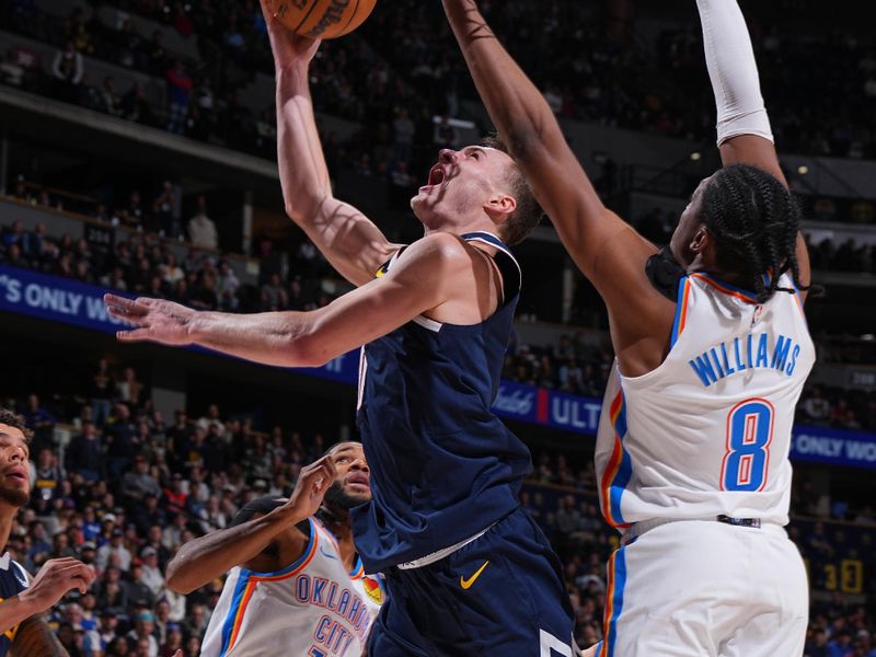 DENVER, CO - NOVEMBER 6: Christian Braun #0 of the Denver Nuggets drives to the basket during the game against the Oklahoma City Thunder on November 6, 2024 at Ball Arena in Denver, Colorado. NOTE TO USER: User expressly acknowledges and agrees that, by downloading and/or using this Photograph, user is consenting to the terms and conditions of the Getty Images License Agreement. Mandatory Copyright Notice: Copyright 2024 NBAE (Photo by Garrett Ellwood/NBAE via Getty Images)