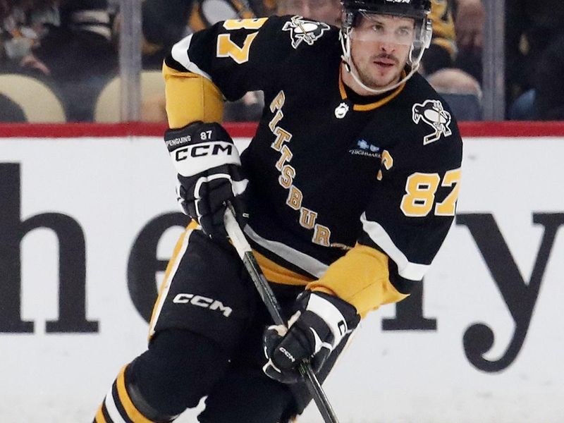 Jan 11, 2024; Pittsburgh, Pennsylvania, USA; Pittsburgh Penguins center Sidney Crosby (87) skates up ice with the puck against the Vancouver Canucks during the first period at PPG Paints Arena. Mandatory Credit: Charles LeClaire-USA TODAY Sports