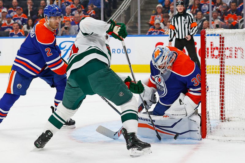 Feb 23, 2024; Edmonton, Alberta, CAN; Minnesota Wild forward Joel Ericksson EK (14) looks for a rebound in front of Edmonton Oilers goaltender Calvin Pickard (30) during the second period at Rogers Place. Mandatory Credit: Perry Nelson-USA TODAY Sports