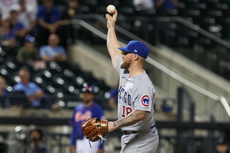 Aug 7, 2023; New York City, New York, USA; Chicago Cubs left fielder Ian Happ (8) throws a pitch during the eighth inning against the New York Mets at Citi Field. Mandatory Credit: Vincent Carchietta-USA TODAY Sports