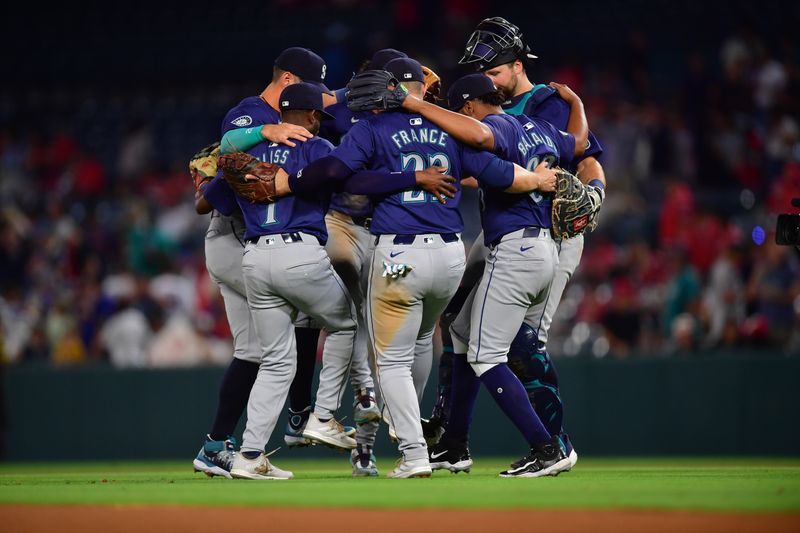 Jul 11, 2024; Anaheim, California, USA; Seattle Mariners and first baseman Ty France (23) celebrate the victory against the Los Angeles Angels at Angel Stadium. Mandatory Credit: Gary A. Vasquez-USA TODAY Sports