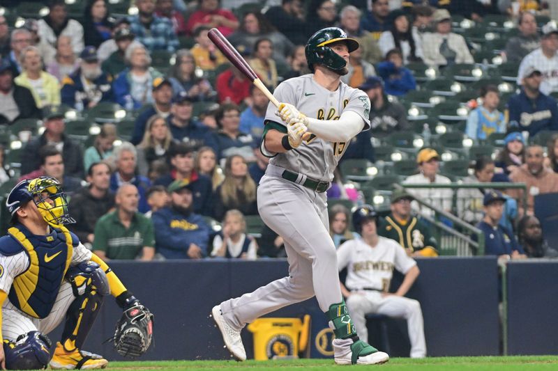 Jun 11, 2023; Milwaukee, Wisconsin, USA; Oakland Athletes left fielder Seth Brown (15) hits a 3-run home run  in the fourth inning as Milwaukee Brewers catcher William Contreras (24) looks on at American Family Field. Mandatory Credit: Benny Sieu-USA TODAY Sports