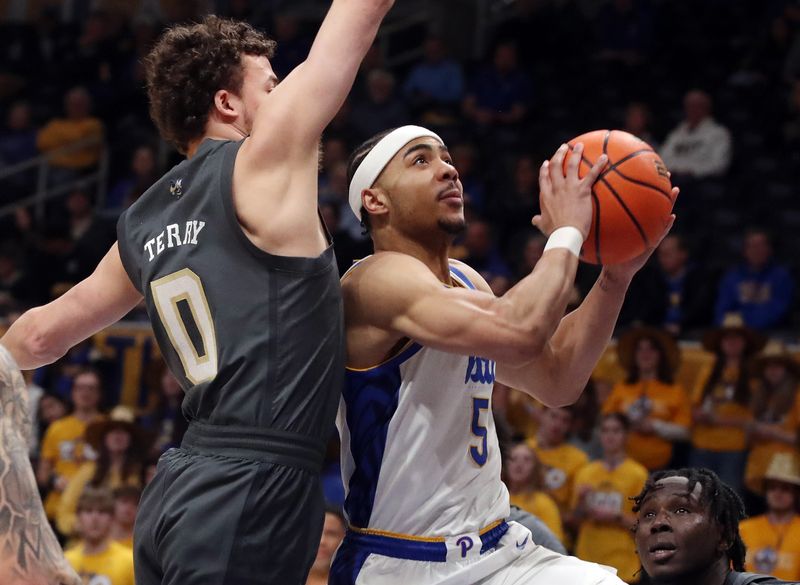 Feb 25, 2025; Pittsburgh, Pennsylvania, USA;  Pittsburgh Panthers guard Ishmael Leggett (5) drives against Georgia Tech Yellow Jackets guard Lance Terry (0) during the first half at the Petersen Events Center. Mandatory Credit: Charles LeClaire-Imagn Images