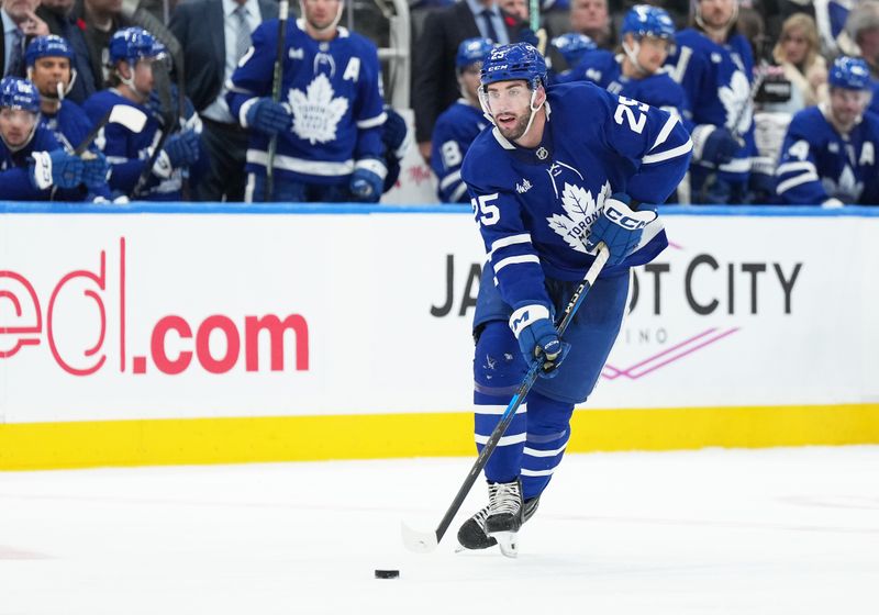 Nov 9, 2024; Toronto, Ontario, CAN; Toronto Maple Leafs defenseman Conor Timmins (25) skates with the puck against the Montreal Canadiens during the third period at Scotiabank Arena. Mandatory Credit: Nick Turchiaro-Imagn Images