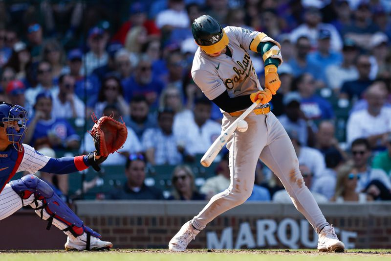 Sep 18, 2024; Chicago, Illinois, USA; Oakland Athletics outfielder Brent Rooker (25) hits an RBI-single against the Chicago Cubs during the seventh inning at Wrigley Field. Mandatory Credit: Kamil Krzaczynski-Imagn Images