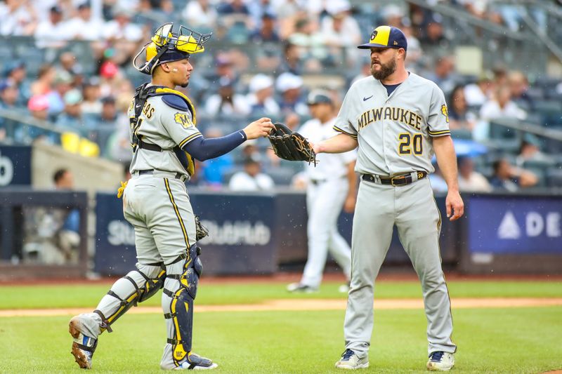 Sep 9, 2023; Bronx, New York, USA;  Milwaukee Brewers catcher William Contreras (24) and starting pitcher Wade Miley (20) have a conference on the mound in the fourth inning against the New York Yankees at Yankee Stadium. Mandatory Credit: Wendell Cruz-USA TODAY Sports