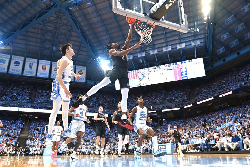 Feb 17, 2024; Chapel Hill, North Carolina, USA; Virginia Tech Hokies guard MJ Collins (2) shoots as North Carolina Tar Heels guard Cormac Ryan (3) defends in the first half at Dean E. Smith Center. Mandatory Credit: Bob Donnan-USA TODAY Sports