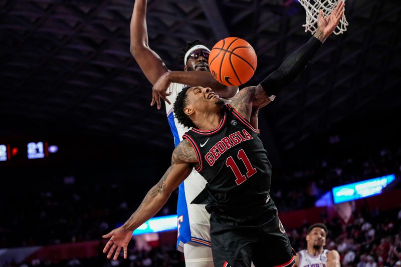 Feb 28, 2023; Athens, Georgia, USA; Georgia Bulldogs guard Justin Hill (11) loses the ball to the defense of Florida Gators center Jason Jitoboh (33) during the second half at Stegeman Coliseum. Mandatory Credit: Dale Zanine-USA TODAY Sports