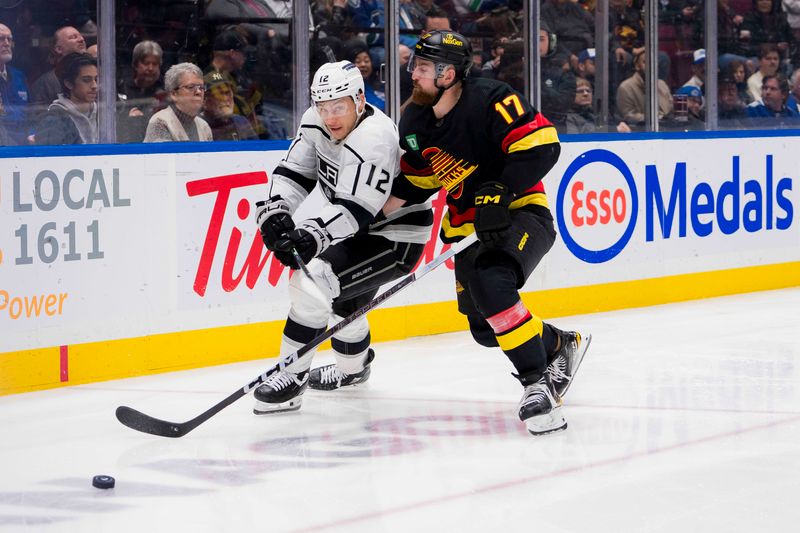 Feb 29, 2024; Vancouver, British Columbia, CAN; Vancouver Canucks defenseman Filip Hronek (17) checks Los Angeles Kings forward Trevor Moore (12) in the third period at Rogers Arena. Kings won 5-1. Mandatory Credit: Bob Frid-USA TODAY Sports