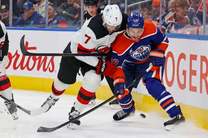 Nov 4, 2024; Edmonton, Alberta, CAN; Edmonton Oilers forward Zach Hyman (18) and New Jersey Devils defensemen Dougie Hamilton (7) battle along the boards for a loose puck during the first period at Rogers Place. Mandatory Credit: Perry Nelson-Imagn Images