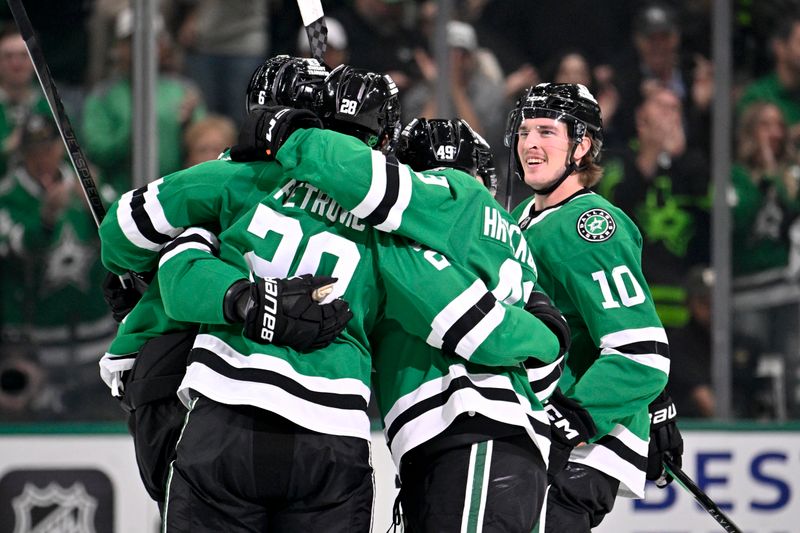 Nov 15, 2025; Dallas, Texas, USA; Dallas Stars defenseman Alexander Petrovic (28) and center Justin Hryckowian (49) and center Oskar Back (10) and defenseman Lian Bichsel (6) and center Mavrik Bourque (22) celebrates a goal scored by Bichsel against the Philadelphia Flyers during the first period at the American Airlines Center. Mandatory Credit: Jerome Miron-Imagn Images