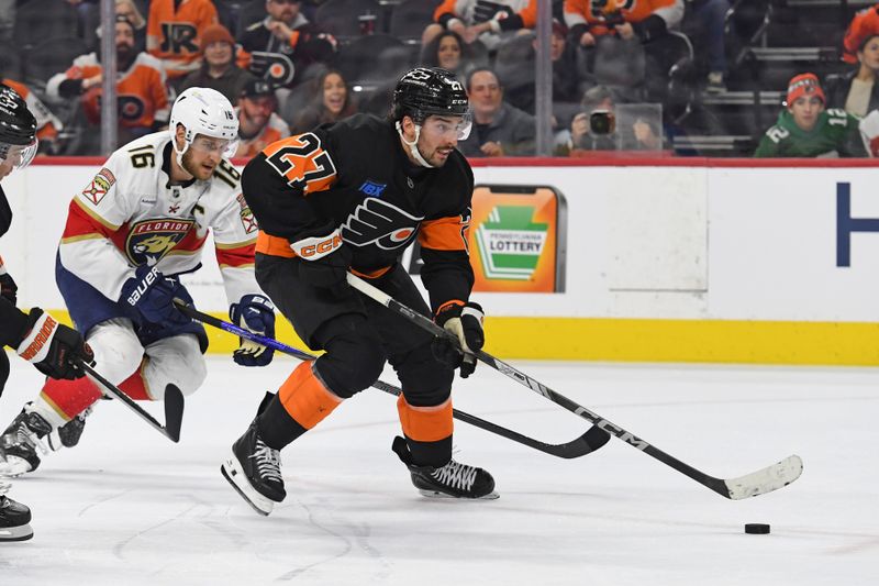 Jan 13, 2025; Philadelphia, Pennsylvania, USA; Philadelphia Flyers left wing Noah Cates (27) skates past Florida Panthers center Aleksander Barkov (16) before scoring a goal during the third period at Wells Fargo Center. Mandatory Credit: Eric Hartline-Imagn Images