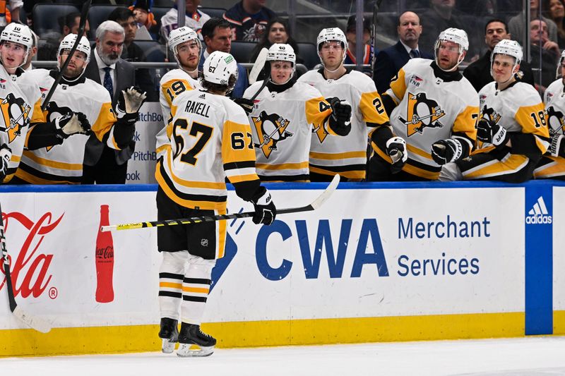 Apr 17, 2024; Elmont, New York, USA;  Pittsburgh Penguins right wing Rickard Rakell (67) celebrates his goal with the bench against the New York Islanders during the first period at UBS Arena. Mandatory Credit: Dennis Schneidler-USA TODAY Sports