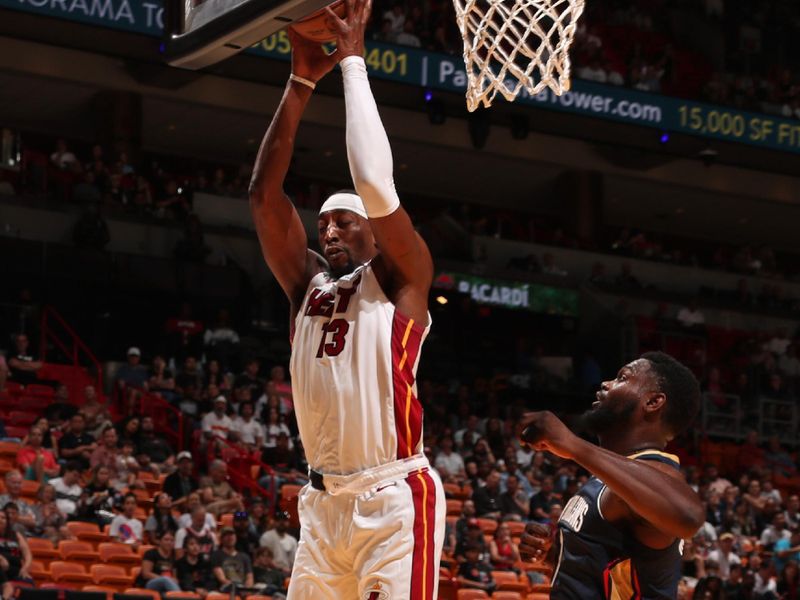 MIAMI, FL - OCTOBER 13: Bam Adebayo #13 of the Miami Heat goes up for the rebound during the game against the New Orleans Pelicans during a NBA pre season game on October 13, 2024 at Kaseya Center in Miami, Florida. NOTE TO USER: User expressly acknowledges and agrees that, by downloading and or using this Photograph, user is consenting to the terms and conditions of the Getty Images License Agreement. Mandatory Copyright Notice: Copyright 2024 NBAE (Photo by Issac Baldizon/NBAE via Getty Images)