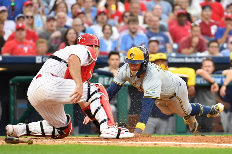 Jun 3, 2024; Philadelphia, Pennsylvania, USA; Milwaukee Brewers first base Rhys Hoskins (12) is tagged out at home by Philadelphia Phillies catcher J.T. Realmuto (10) during the fifth inning at Citizens Bank Park. Mandatory Credit: Eric Hartline-USA TODAY Sports