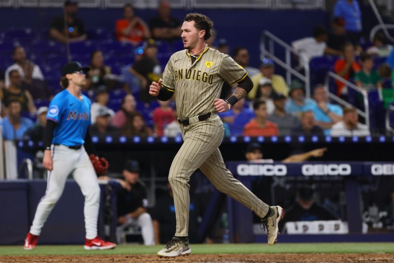Aug 11, 2024; Miami, Florida, USA; San Diego Padres center fielder Jackson Merrill (3) scores after an RBI double by right fielder David Peralta (not pictured) during the seventh inning at loanDepot Park. Mandatory Credit: Sam Navarro-USA TODAY Sports