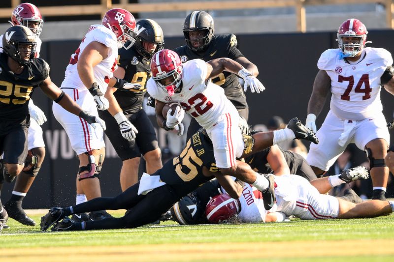 Oct 5, 2024; Nashville, Tennessee, USA;  Alabama Crimson Tide running back Justice Haynes (22) breaks the tackle of Vanderbilt Commodores cornerback Martel Hight (25) during the first half at FirstBank Stadium. Mandatory Credit: Steve Roberts-Imagn Images