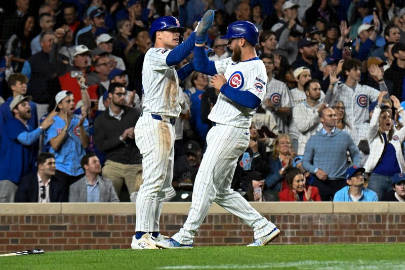 Sep 24, 2025; Chicago, Illinois, USA;  Chicago Cubs third baseman Matt Shaw (6) and Chicago Cubs first baseman Michael Busch (29) high five after they score against the New York Mets during the third inning at Wrigley Field. Mandatory Credit: Matt Marton-Imagn Images