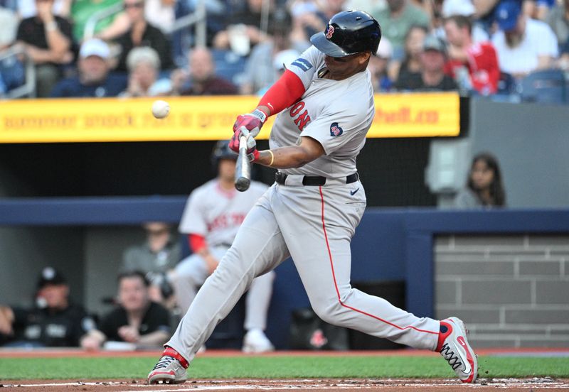 Jun 17, 2024; Toronto, Ontario, CAN;  Boston Red Sox third baseman Rafael Devers (11) hits a solo home run against the Toronto Blue Jays in the first inning at Rogers Centre. Mandatory Credit: Dan Hamilton-USA TODAY Sports