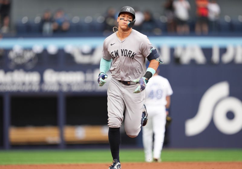 Jun 30, 2024; Toronto, Ontario, CAN; New York Yankees designated hitter Aaron Judge (99) runs the bases after hitting a two run home run against the Toronto Blue Jays during the first inning at Rogers Centre. Mandatory Credit: Nick Turchiaro-USA TODAY Sports