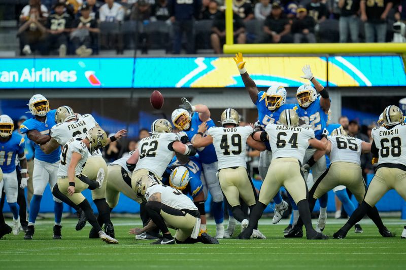 New Orleans Saints place kicker Blake Grupe (19) kicks a field goal in the first half of an NFL football game against the Los Angeles Chargers in Inglewood, Calif., Sunday, Aug. 20, 2023. (AP Photo/Marcio Jose Sanchez)