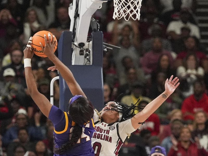 Mar 10, 2024; Greensville, SC, USA; LSU Lady Tigers forward Angel Reese (10) goes up for a shot against South Carolina Gamecocks guard Te-Hina Paopao (0) during the second half at Bon Secours Wellness Arena. Mandatory Credit: Jim Dedmon-USA TODAY Sports