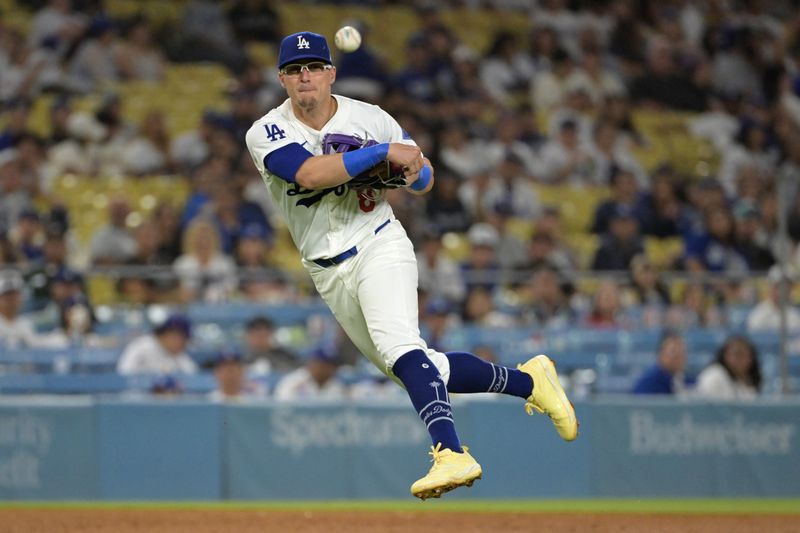 Jul 24, 2024; Los Angeles, California, USA;  Los Angeles Dodgers third baseman Enrique Hernandez (8) makes a play to throw out San Francisco Giants center fielder Tyler Fitzgerald (49) at first in the eighth inning at Dodger Stadium. Mandatory Credit: Jayne Kamin-Oncea-USA TODAY Sports