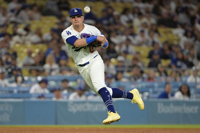 Jul 24, 2024; Los Angeles, California, USA;  Los Angeles Dodgers third baseman Enrique Hernandez (8) makes a play to throw out San Francisco Giants center fielder Tyler Fitzgerald (49) at first in the eighth inning at Dodger Stadium. Mandatory Credit: Jayne Kamin-Oncea-USA TODAY Sports