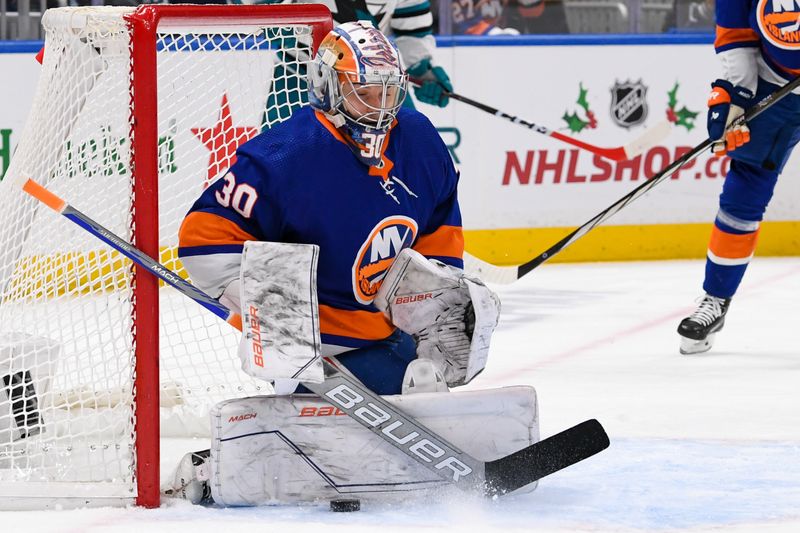 Dec 5, 2023; Elmont, New York, USA; New York Islanders goaltender Ilya Sorokin (30) makes a save against the San Jose Sharks during the first period at UBS Arena. Mandatory Credit: Dennis Schneidler-USA TODAY Sports