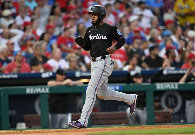 Jun 27, 2024; Philadelphia, Pennsylvania, USA; Miami Marlins outfielder Bryan De La Cruz (14) advances home to score against the Philadelphia Phillies in the seventh inning at Citizens Bank Park. Mandatory Credit: Kyle Ross-USA TODAY Sports