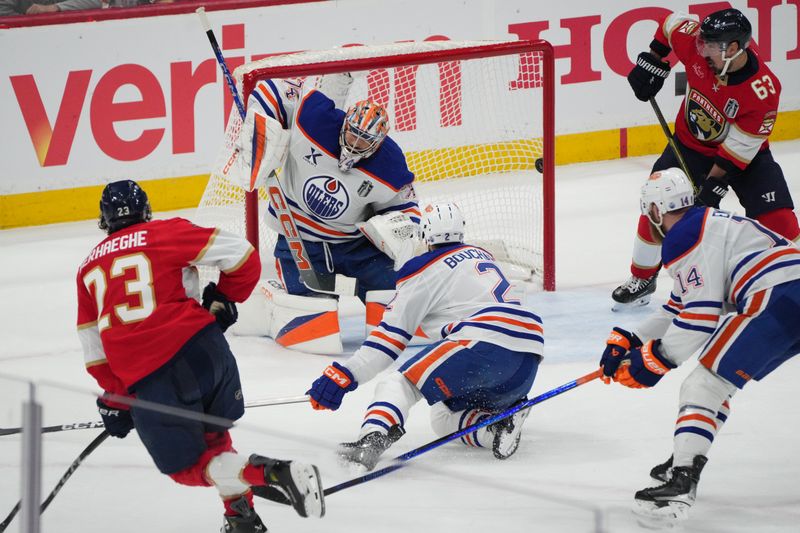 Jun 9, 2025; Sunrise, Florida, USA; Florida Panthers forward Carter Verhaeghe (23) scores against Edmonton Oilers goaltender Stuart Skinner (74) and defenseman Evan Bouchard (2) during the first period in game three of the 2025 Stanley Cup Final at Amerant Bank Arena. Mandatory Credit: Jim Rassol-Imagn Images
