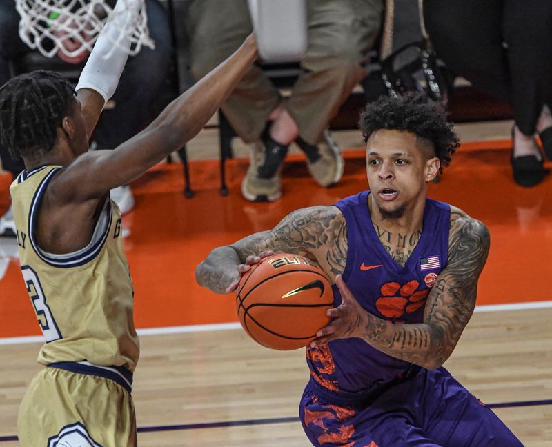 Jan 24, 2023; Clemson, South Carolina, USA; Clemson Tigers guard Brevin Galloway (11) moves the ball against Georgia Tech Yellow Jackets forward Jordan Meka (23) during the first half at Littlejohn Coliseum. Mandatory Credit: Ken Ruinard-USA TODAY Sports