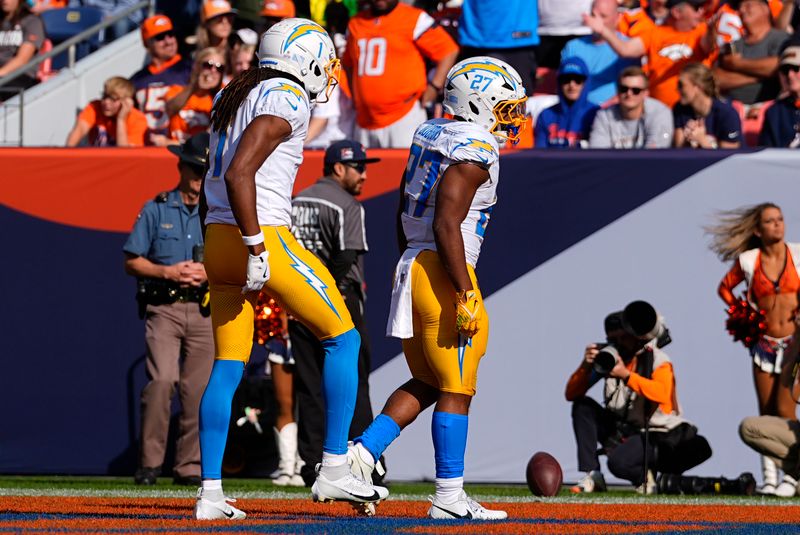 Los Angeles Chargers running back J.K. Dobbins (27) celebrates after scoring a 4-yard touchdown during the first half of an NFL football game against the Denver Broncos, Sunday, Oct. 13, 2024, in Denver. (AP Photo/David Zalubowski)