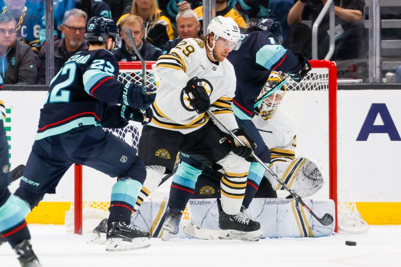 Feb 26, 2024; Seattle, Washington, USA; Boston Bruins defenseman Parker Wotherspoon (29) clears the puck away from goaltender Linus Ullmark (35) against the Boston Bruins during the second period at Climate Pledge Arena. Mandatory Credit: Joe Nicholson-USA TODAY Sports