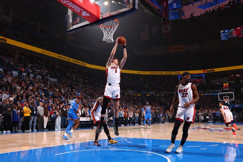 OKLAHOMA CITY, OK - MARCH 8:  Nikola Jovic #5 of the Miami Heat grabs a rebound during the game against the Oklahoma City Thunder on March 8, 2024 at Paycom Arena in Oklahoma City, Oklahoma. NOTE TO USER: User expressly acknowledges and agrees that, by downloading and or using this photograph, User is consenting to the terms and conditions of the Getty Images License Agreement. Mandatory Copyright Notice: Copyright 2024 NBAE (Photo by Zach Beeker/NBAE via Getty Images)